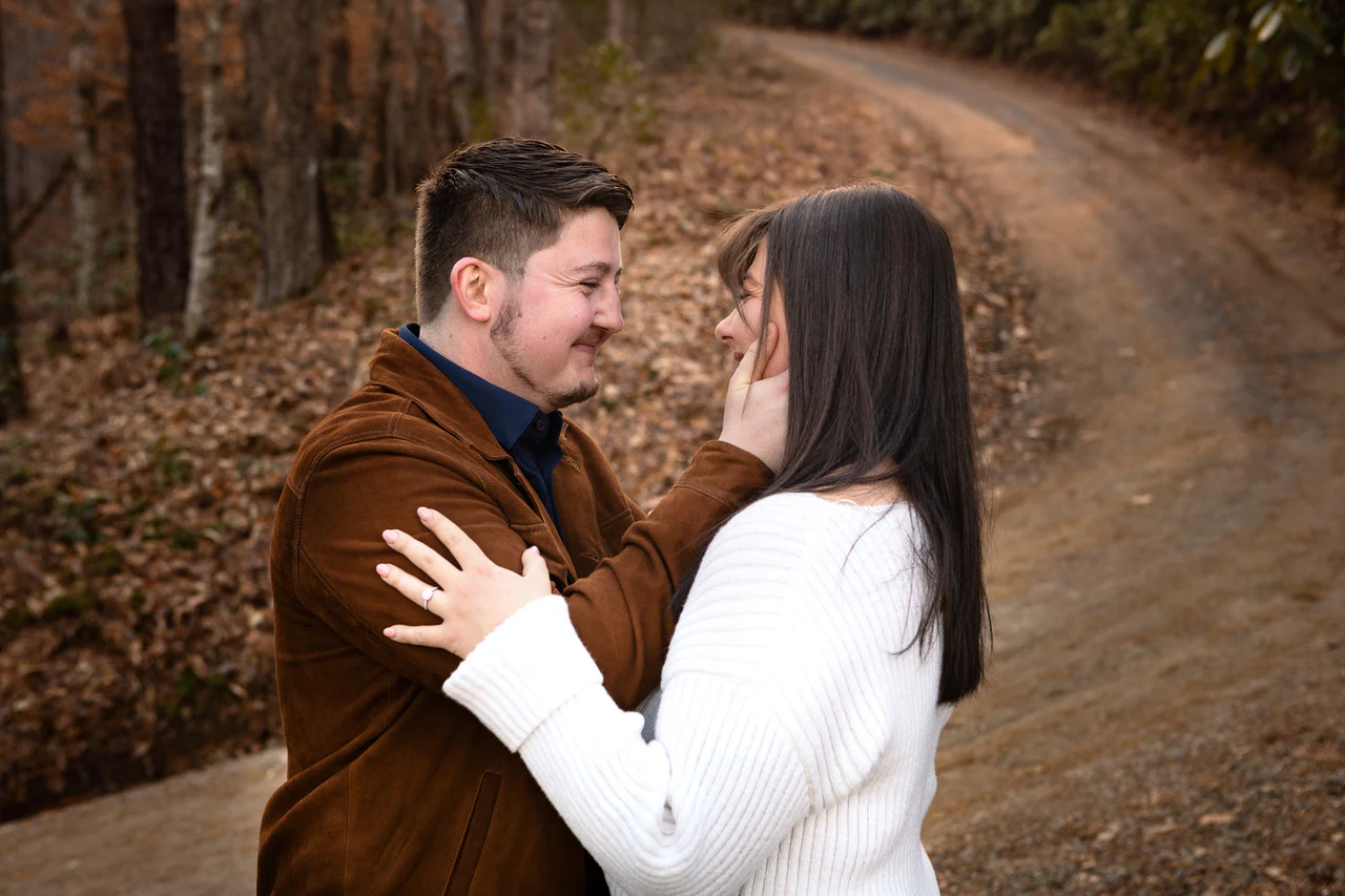 Gage and Riley looking at each other on a wooded road